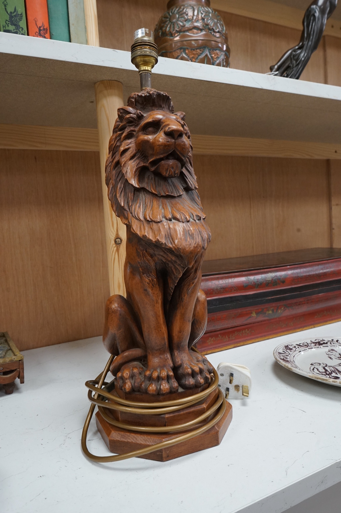 A Thomas Blakemore faux oak seated lion lamp base, 46cm total height. Condition - good